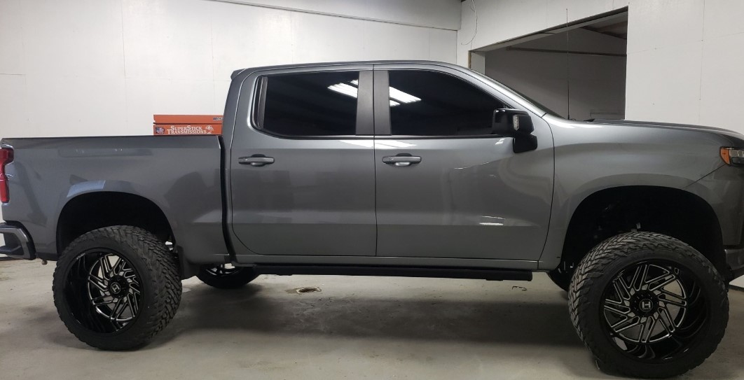 Gray Chevy pickup side profile with dark tinted cab windows